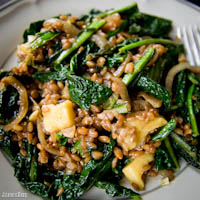 Spinach, farro, and onion stirfry with cheese and soy sauce